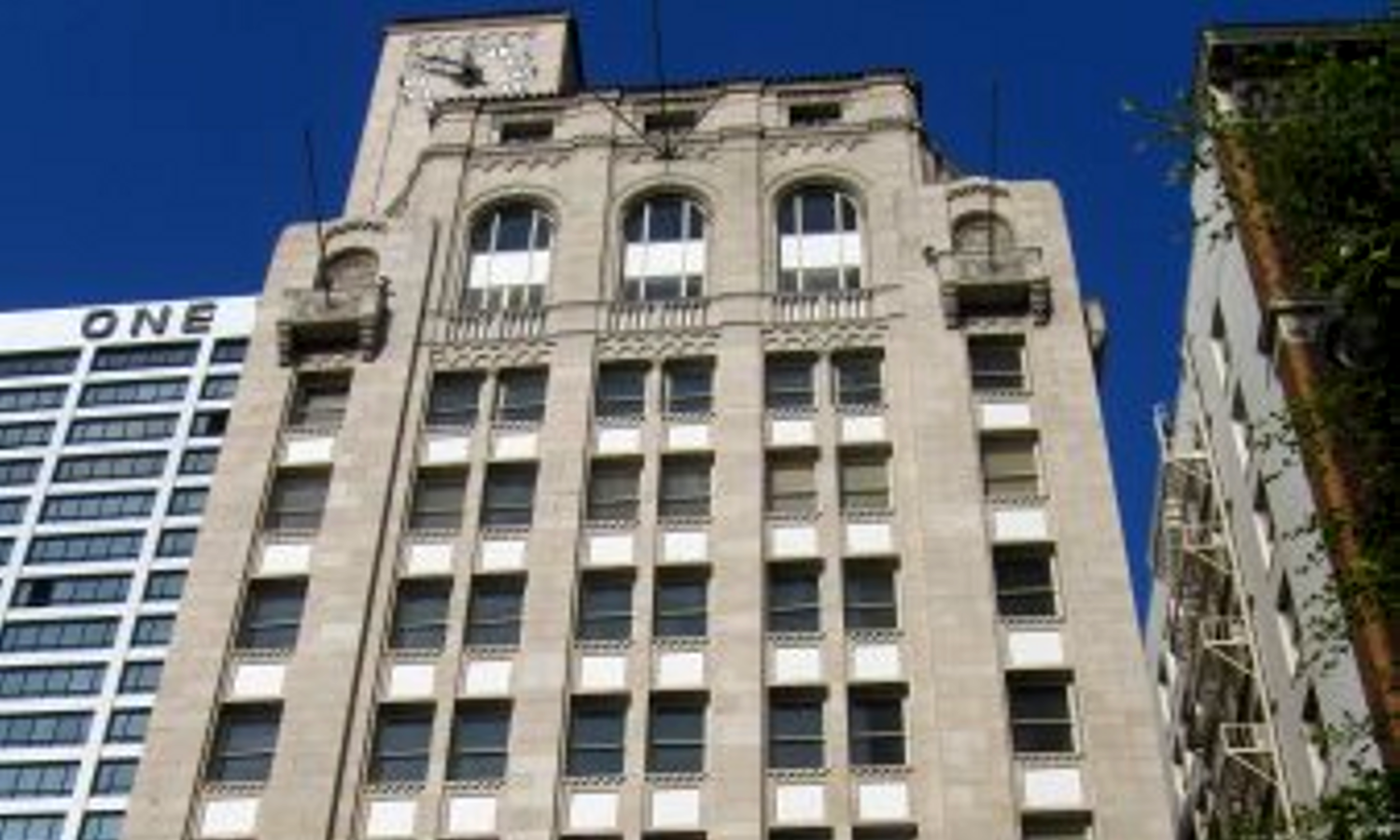 Picture of top of grey bricked multi-storey building. 