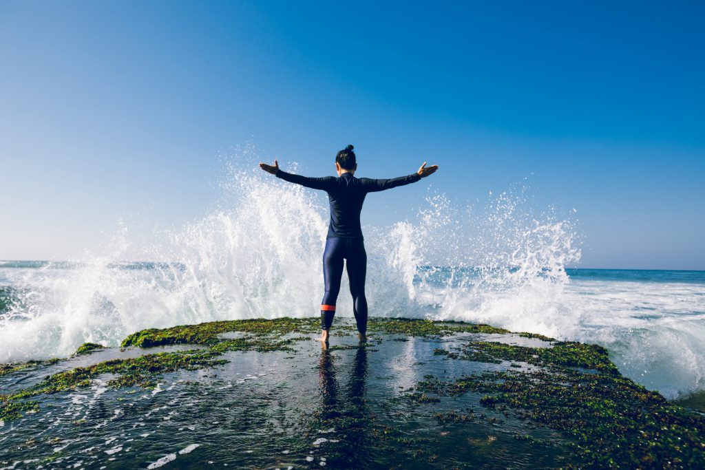 Woman standing by the waves